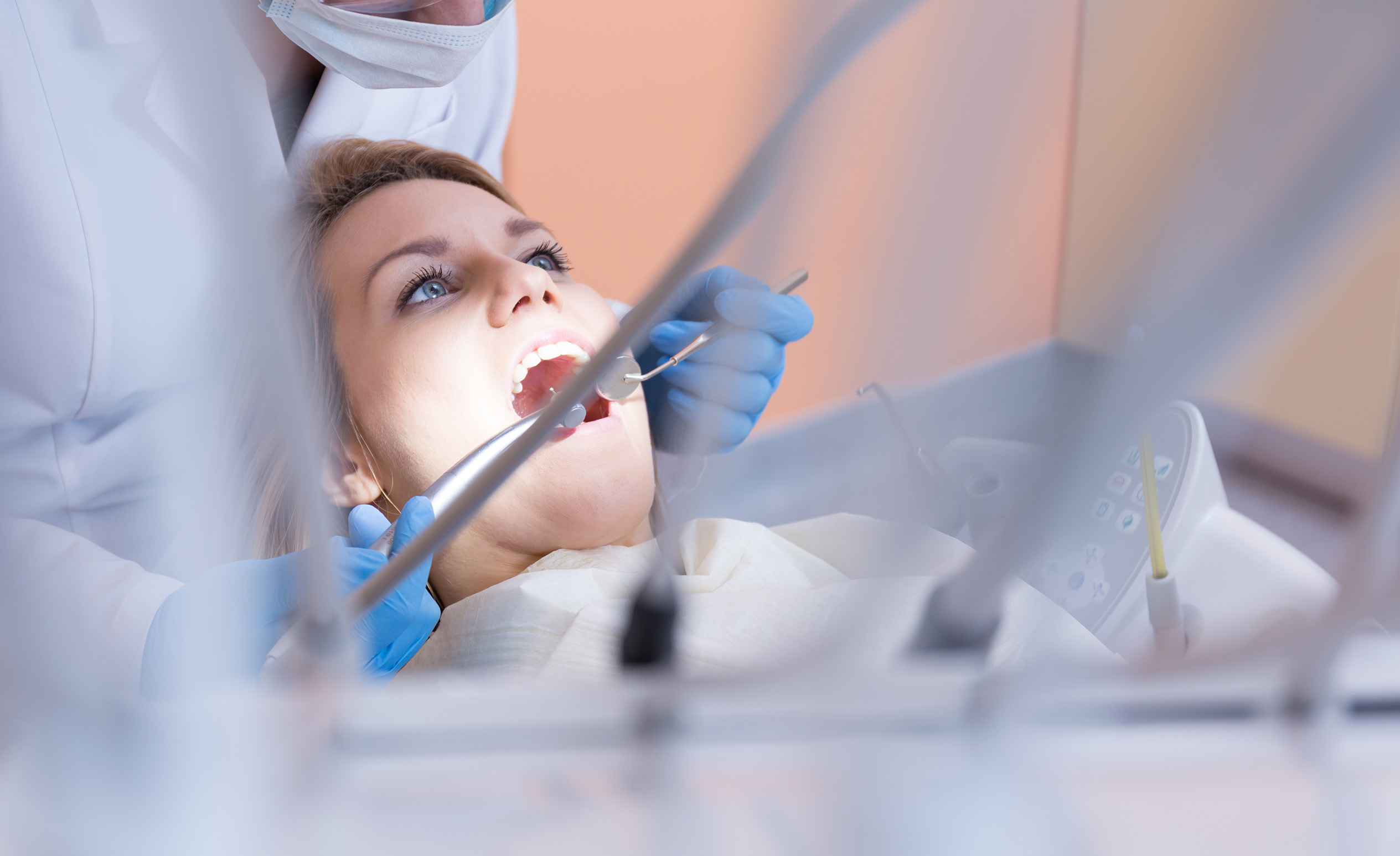 Fúrjak egy kék szemű nőnek fogát a budapesti fogorvosi rendelőben.