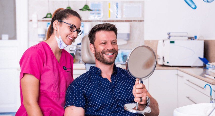 Gyökérkezelés után Dr. Ökrös Petra fogorvos és páciense mosolyog.